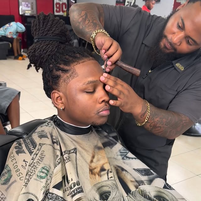 Speedy shaping a client’s hairline in the barber chair